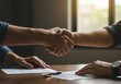 © Nathan - Handshake over Desk Documents Near Sunlit Window