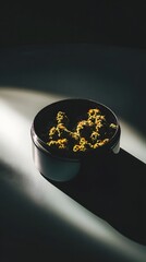 Poster - Close up view of cannabis buds in a container with soft directional lighting creating a cinematic and contemporary atmosphere