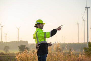 Wall Mural - engineer wearing uniform inspection and survey work in wind turbine farms rotation to generate elect