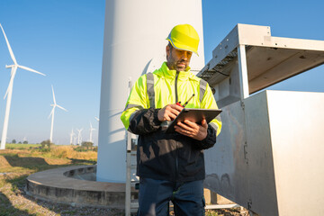 Wall Mural - engineer wearing uniform inspection and survey work in wind turbine farms rotation to generate elect