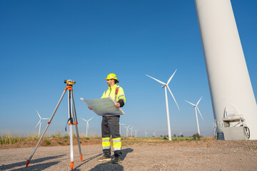 Wall Mural - engineer wearing uniform inspection and survey work in wind turbine farms rotation to generate elect
