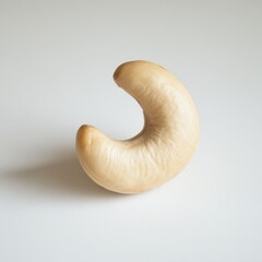 Aufkleber - Single cashew nut on a plain white background, showcasing its smooth texture, crescent shape, and healthy snack appeal