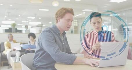 Poster - Two coworkers collaborating at round wooden table, displaying data security interface overlay