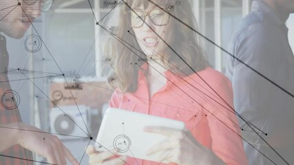 Poster - Woman holding tablet speaking with colleagues in tech office, network graphics floating over desk