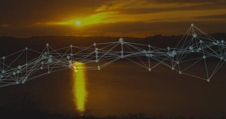 Poster - Digital network nodes stretching across lake at sunset, reflecting golden sky on water