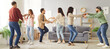 © Studio Romantic - Group of happy friends dancing together at home during a weekend party, celebrating with lively music and entertainment. Fun atmosphere, sharing joyful moments in a relaxed and cheerful setting.