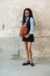 © Mykola - A Chic Outfit Featuring a Bright Brown Backpack Paired with Stylish and Trendy Dress and Blue Shirt