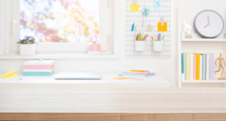 Wall Mural - blank wooden board for product display on blurred schooler table and room interior background
