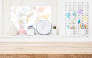 Wall Mural - empty wooden table top for product display on blurred schooler room window sill interior background
