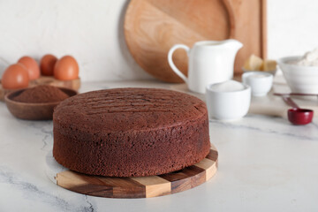 Wall Mural - delicious chocolate sponge cake with ingredients on marble table