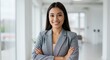 © Arthure  - Smiling Woman in Blazer with Arms Crossed in Office