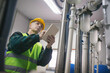 © Aleksandar - Senior maintenance engineer checking the system in the boiler room
