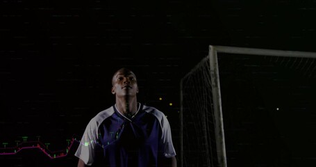Poster - Male soccer player standing in night field by goalpost, displaying live sports analytics overlays