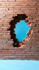 Poster - Brick wall with a hole revealing blue sky offering a concept of escape freedom and opportunity against a minimalist background in a studio shot with a medium angle