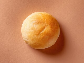 Poster - Golden round bun on a pastel background showcasing its soft texture and inviting appeal perfect for food photography and culinary projects