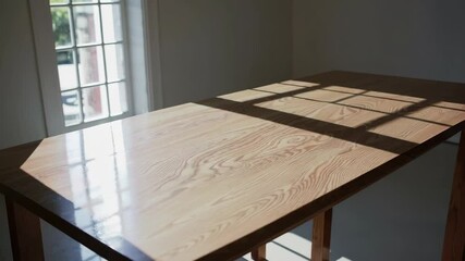 Poster - Sunlit Wooden Table with Geometric Shadows in Minimalist Setting