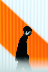 Poster - Stylish man walking by orange and white striped wall