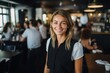 © Vorda Berge - Smiling portrait of a young female Caucasian waiter in a cafe