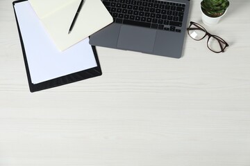Aufkleber - Flat lay composition with office supplies, laptop, glasses and houseplant on light wooden table. Space for text