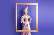 © deagreez - Elegant woman in historical royal gown framed on vibrant violet background