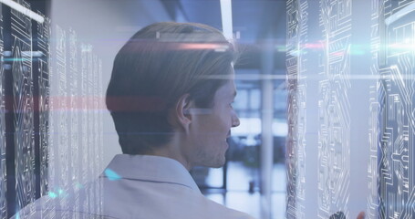 Poster - image of lights over caucasian men in server room