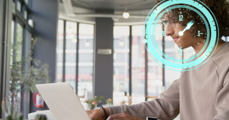 Poster - Image of clock moving over biracial businessman using laptop