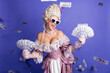 © deagreez - Elegant woman in baroque costume holding money against colorful background illustrating luxury and humor.
