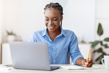 Aufkleber - Online Education. Young Black Female Student Using Laptop At Home And Taking Notes, Smiling African American Woman Enjoying Distance Learning, Watching Webinar In Internet, Copy Space