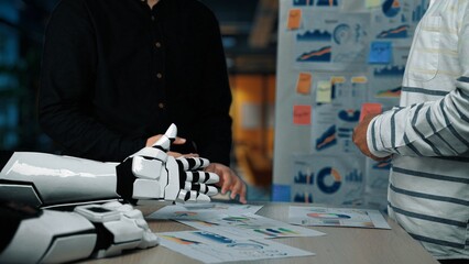 Poster - a dynamic business meeting featuring a robot hand alongside a human, analyzing charts and graphs, hi