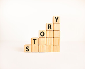 Fototapete - Story symbol. Concept word Story on beautiful wooden blocks. Beautiful white table white background. Business lifestyle story concept. Copy space.
