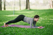 © PSG - Asian woman doing yoga in a garden with trees for health and exercise.