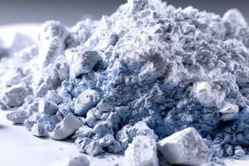 Poster - a close-up of a textured, powder-like substance with shades of white and pale blue, creating a rough