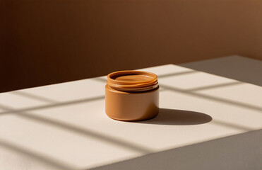 Aufkleber - a small jar with a lid removed sits on a light surface, casting sharp shadows in a simple, minimalis