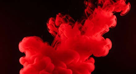 Poster - A vibrant red cloud of ink swirling in dark water creating an abstract and dramatic visual effect