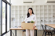 © David - Business woman with box cardboard packing personal items after losing jobs. asian business woman standing on office background. Your fired Unemployed Jobless People Crisis