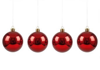 Wall Mural - Four shiny red christmas ornaments hanging in a row against a stark white background in a studio shot