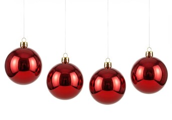 Wall Mural - Four shiny red christmas ornaments hanging against a plain white background in a horizontal line