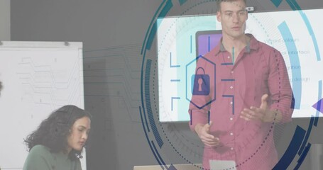 Poster - Man presenting UI on large display in modern office, woman writing notes with cybersecurity overlay