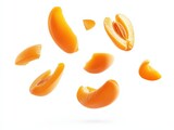 Falling slices apricot cut into pieces floating in the air with sharp shapes isolated on white background