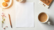 © Olga's Design - Cozy home workspace with white A4 paper sheet and coffee in soft morning light