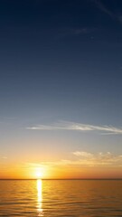 Wall Mural - sunrise over the sea with gentle waves and fading stars in a peaceful, dreamy atmosphere