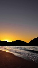 Wall Mural - sunrise over the sea with gentle waves and fading stars in a peaceful, dreamy atmosphere