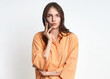 © Marina - Young caucasian female in orange shirt talking on smartphone