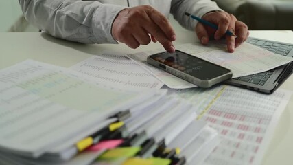 Poster - businessman uses a calculator and paperwork to analyze finances, investments, and tax reports at his desk calculator and digital tablet. business financial reports and data analysis				