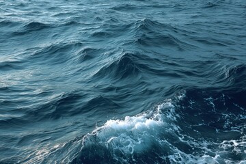 Poster - Deep blue ocean water with rolling waves and white foam creating a dynamic seascape of natural beauty and power under sunlight in an aerial view
