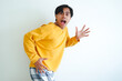© Muhammad Alimaki - Funny surprised expression of Asian man looking at camera, isolated portrait with humorous reaction