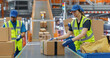 © Gorodenkoff - Diverse Workers in Safety Vests Loading Parcels Onto a Conveyor in a Modern Sorting Center Facility. People Working Together as a Team in Logistics and Postal Service Operations