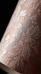 Poster - Close-up of embossed peach-colored textile with floral pattern, showcasing texture and detail, ideal for background or design element