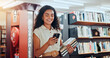 © Jessy/peopleimages.com - Smile, woman and student with phone in library for social media, reading chat and university app. Female person, walk and mobile for learning agenda, scholarship application and studying notification