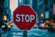 © lashkhidzetim - stop sign is in the middle of a busy city street. The sign is red and white and is surrounded by cars and people. Scene is busy and bustling, with the stop sign serving as a reminder to slow down